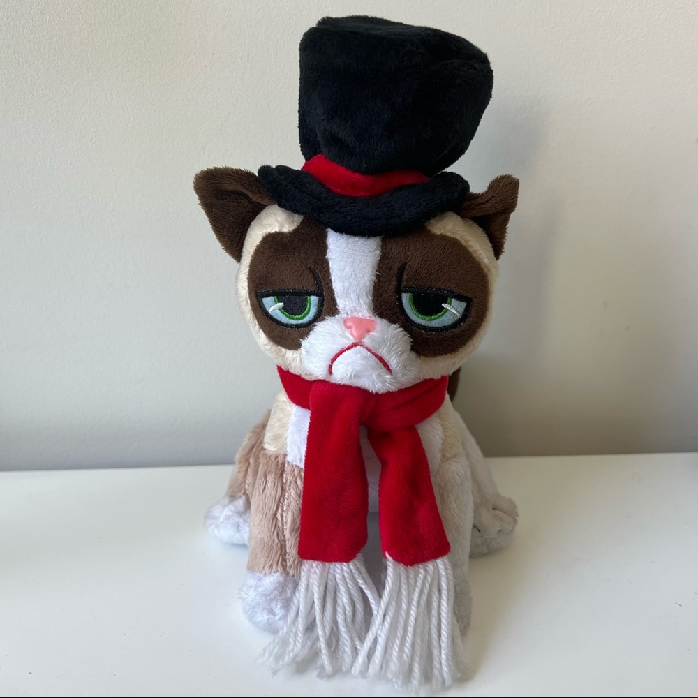 Grumpy Cat plush toy in a fancy hat and scarf